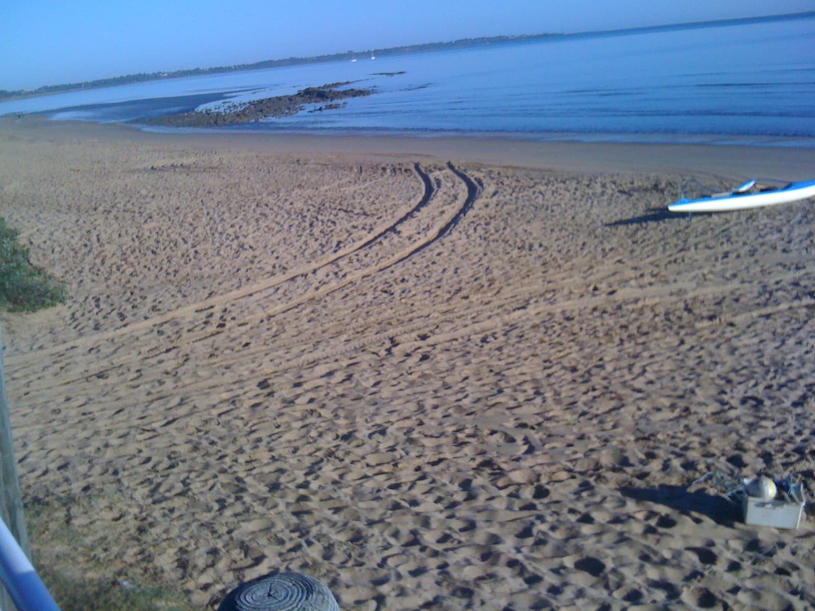 The beach on the Torquay foreshore at Hervey Bay, with a small boat on the sand