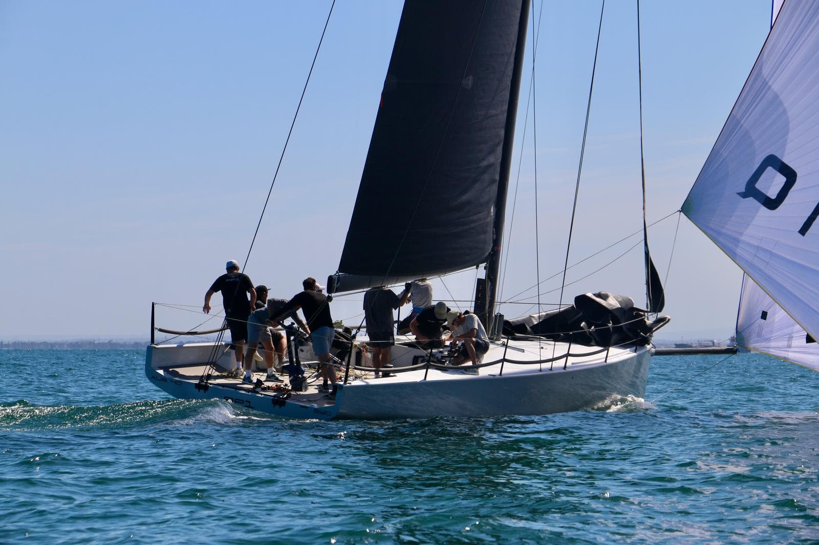 Invicta's crew racing the boat close to the fleet