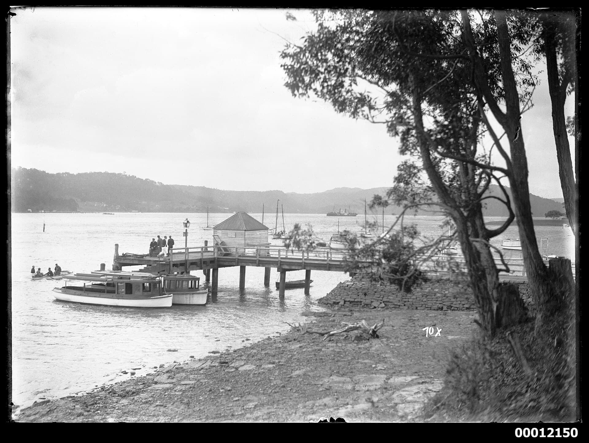 Launches and yachts moored at Newport wharf on Pittwater