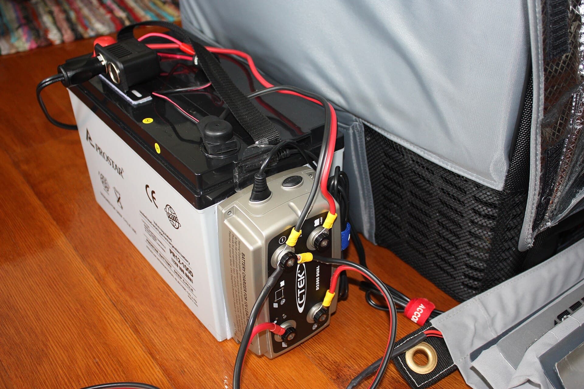 A 100Ah AGM deep-cycle auxiliary battery wired to a CTEK charger